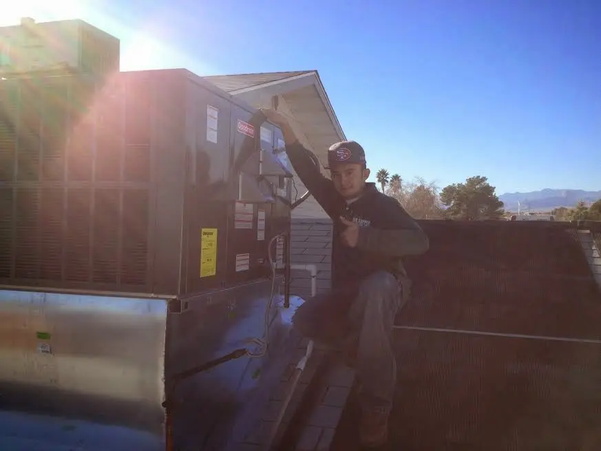 HVAC technician performing HVAC Inspection on a rooftop unit in Indianapolis